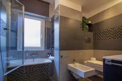a bathroom with a sink and a shower and a tub and a sink at 8bit Dreams - Al Pigneto - 100 m da Metro Malatesta in Rome