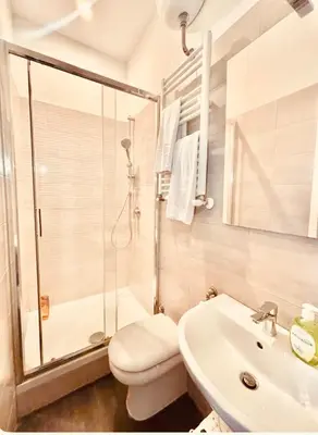 a bathroom with a toilet and a sink and a shower at La Dimora di Sara a 10 minuti da Termini in Rome