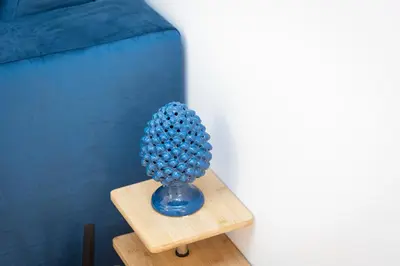 a blue vase filled with balls sitting on a table at Amazing Via del Corso 277 Suites in Rome