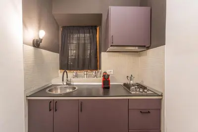 a kitchen with a sink and a counter top at Glam Nest & Garden Colosseum in Rome