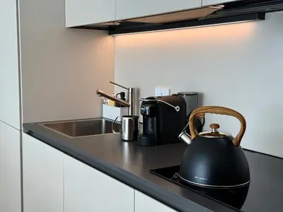 a black tea kettle sitting on a kitchen counter at Suite with Private Courtyard - Colosseum & Forum in Rome