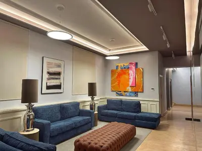 a living room with blue couches and a stool at Suite with Private Courtyard - Colosseum & Forum in Rome