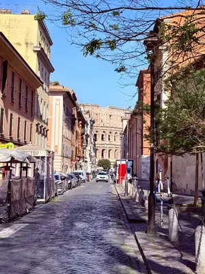 a city street with a building in the background at Suite with Private Courtyard - Colosseum & Forum in Rome