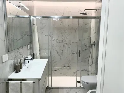 a bathroom with a shower and a sink and a toilet at Suite with Private Courtyard - Colosseum & Forum in Rome