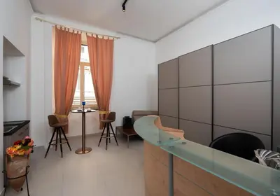 a living room with a glass cabinet and a table at Alida Rooms in Rome