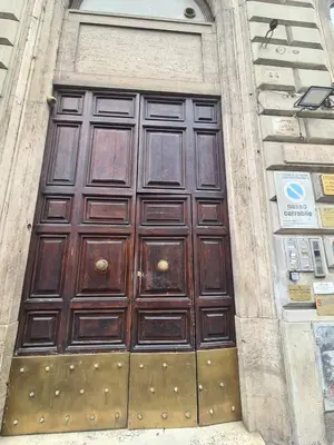a large wooden door on the side of a building at Alida Rooms in Rome