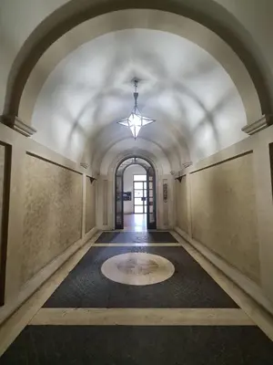 an empty hallway with a ceiling with a chandelier at Alida Rooms in Rome