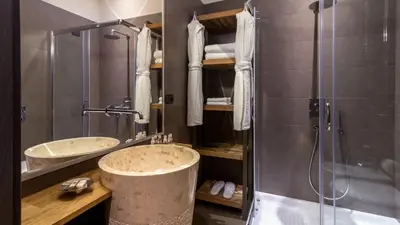 a bathroom with two sinks and a shower at QT Suites Roma in Rome