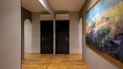 a large painting on the wall in a hallway at QT Suites Roma in Rome