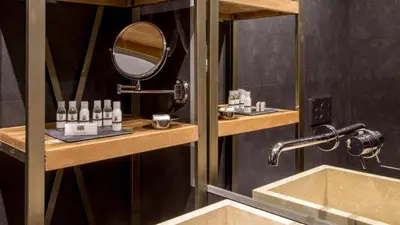a bathroom with a sink and a mirror at QT Suites Roma in Rome