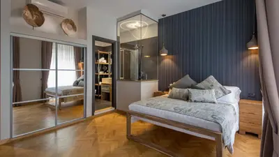 a bedroom with a bed and a mirror at QT Suites Roma in Rome
