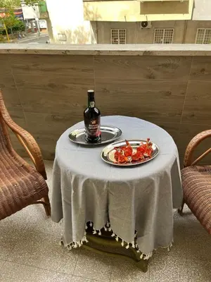 a table with a bottle of wine and a plate of food at Casa Jasmine in Rome