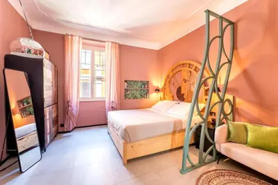 a bedroom with a bed and a chair in it at B HOUSE - luxury apartment Trastevere in Rome