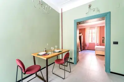 a dining room with a table and red chairs at B HOUSE - luxury apartment Trastevere in Rome