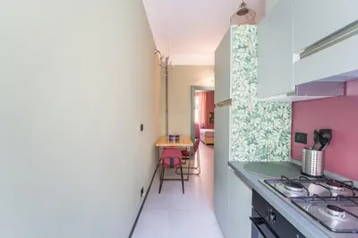a kitchen with pink and white walls and a stove at B HOUSE - luxury apartment Trastevere in Rome