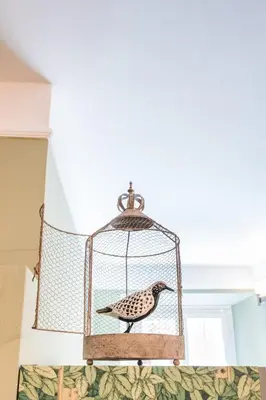 a bird in a cage hanging from a ceiling at B HOUSE - luxury apartment Trastevere in Rome