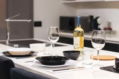 a table with glasses and a bottle of wine at FLORA- Loft Luxury - tra Colosseo e Santa Maria Maggiore - Metro in Rome
