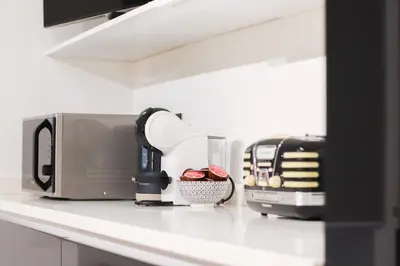 a kitchen counter with a toaster and a coffee maker at FLORA- Loft Luxury - tra Colosseo e Santa Maria Maggiore - Metro in Rome