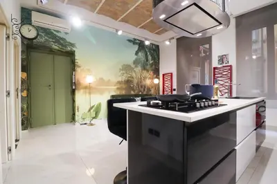 a kitchen with a stove and a clock on the wall at FLORA- Loft Luxury - tra Colosseo e Santa Maria Maggiore - Metro in Rome