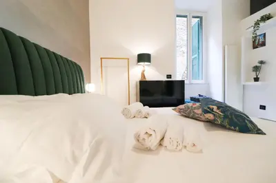 a bedroom with a white bed with towels on it at FLORA- Loft Luxury - tra Colosseo e Santa Maria Maggiore - Metro in Rome