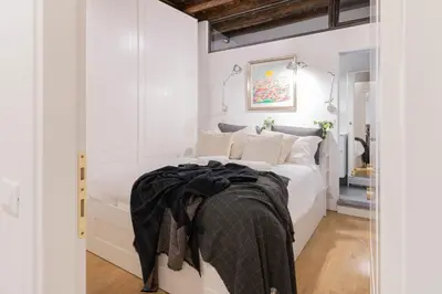 a bedroom with a bed with a black blanket on it at Trilussa Spacious Apartment in Rome