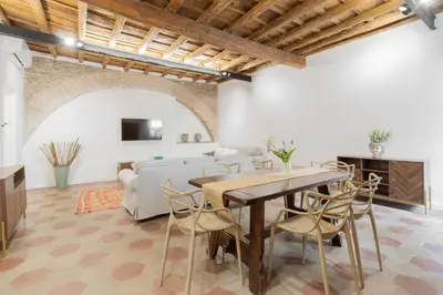 a living room with a table and a couch at Trilussa Spacious Apartment in Rome