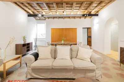 a living room with a couch and a table at Trilussa Spacious Apartment in Rome