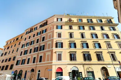 a large yellow building with many windows at River House in Rome