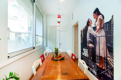 a dining room with a table and a movie poster at River House in Rome