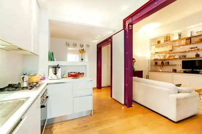 a kitchen and living room with a white couch in a room at River House in Rome