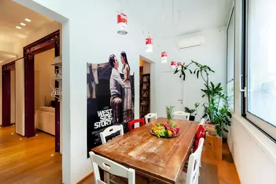 a dining room with a wooden table and chairs at River House in Rome