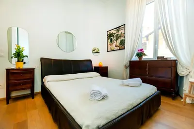 a bedroom with a bed with two towels on it at River House in Rome
