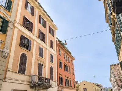 a tall building with windows and a blue sky at Colosseum suites apartment - Zen 22 in Rome