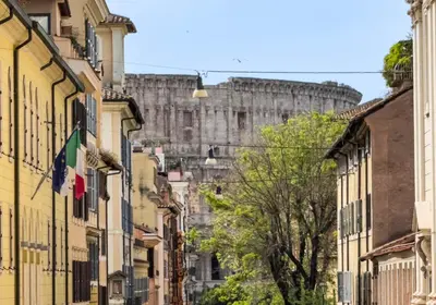 a street with buildings in front of a castle at Colosseum suites apartment - Zen 22 in Rome