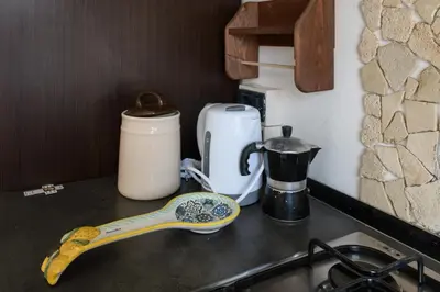 a kitchen counter with a sink with a spoon on it at Pigneto Apartment in Rome
