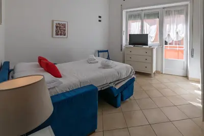 a small bedroom with a bed and a television at Pigneto Apartment in Rome
