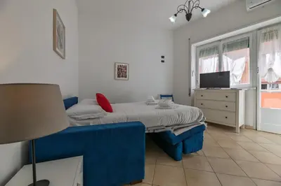 a bedroom with two beds and a tv in it at Pigneto Apartment in Rome