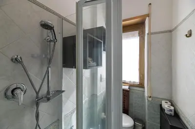 a shower with a glass door in a bathroom at Pigneto Apartment in Rome