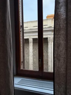 an open window with a view of a building at Spiriti Home Apartment , New Opening Piazza di Pietra in Rome