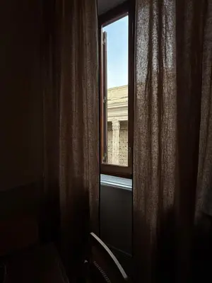 a window with a view of a building at Spiriti Home Apartment , New Opening Piazza di Pietra in Rome