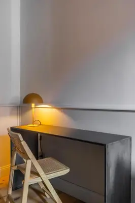 a desk with a lamp and a wooden chair at Spiriti Home Apartment , New Opening Piazza di Pietra in Rome