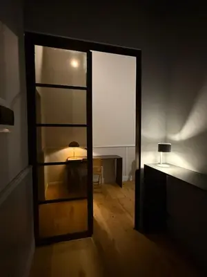 a room with a mirror and a table and a lamp at Spiriti Home Apartment , New Opening Piazza di Pietra in Rome
