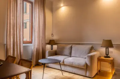 a living room with a couch and a table at Spiriti Home Apartment 2, New Opening Piazza di Pietra in Rome