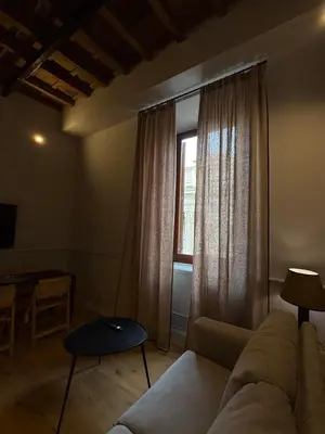 a living room with a couch and a window at Spiriti Home Apartment 2, New Opening Piazza di Pietra in Rome