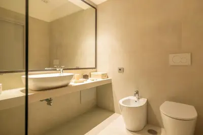 a bathroom with a sink and a toilet and a mirror at Spiriti Home Apartment 2, New Opening Piazza di Pietra in Rome