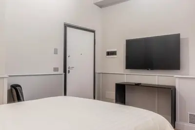 a bedroom with a bed and a flat screen tv at Spiriti Home Apartment 3, New Opening Piazza di Pietra in Rome