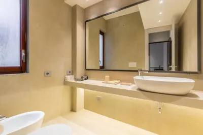 a bathroom with two sinks and a large mirror at Spiriti Home Apartment 3, New Opening Piazza di Pietra in Rome