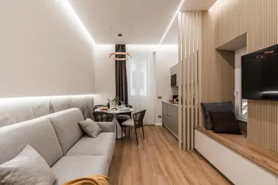 a living room with a couch and a table at The Best Rent - Atmosphere and romance: one-bedroom apartment just steps from the Colosseum in Rome