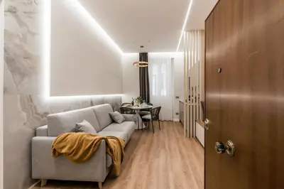 a living room with a couch and a table at The Best Rent - Atmosphere and romance: one-bedroom apartment just steps from the Colosseum in Rome