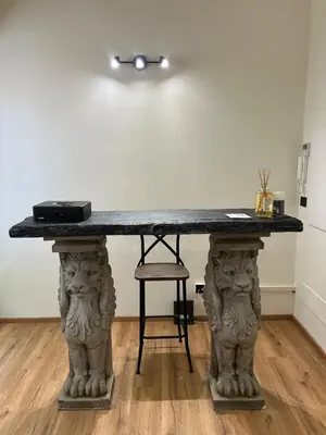 a table with two lions on top of it at By Lina in Trastevere in Rome